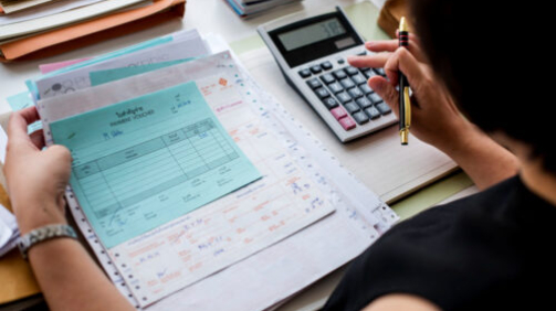 asian-woman-working-through-paperwork