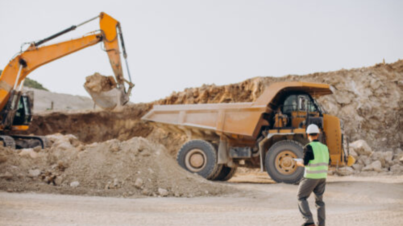 Male worker with bulldozer in sand quarry