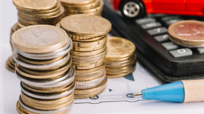 16. close-up-stacked-coins-pen-calculator (1)