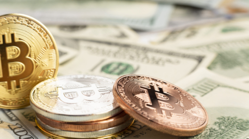 bitcoin-pile-top-dolar-bills