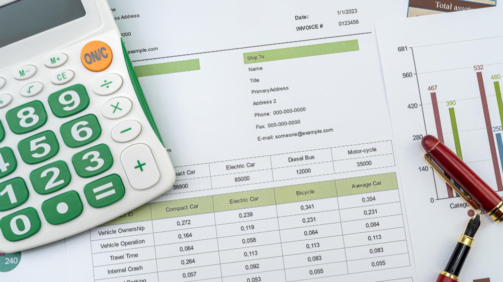 workplace-business-chart-showing-financial-success-with-pen-calculator (1)